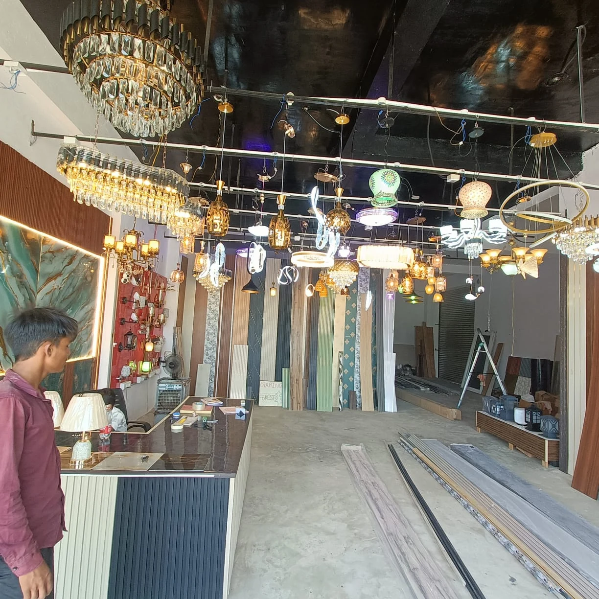 Inside UV Interio showroom with wall panels and decorative lights